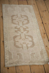 Distressed Oushak rug runner: geometric medallion detail, antique ivory, beige, and faint abrashes.