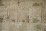 Distressed geometric diamond guls and muted blossoms with olive green abrashes, vintage Melas rug.