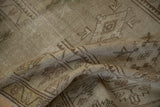 Distressed Melas rug's hand-knotted texture with heavy abrashes and geometric forms.