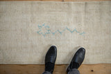 Worn, nubby texture of an ivory Oushak runner with a powder blue floral design.