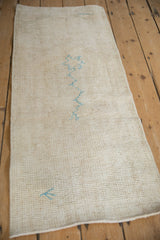 Reverse side of a vintage Turkish Oushak runner showing its hand-knotted weave and painted numbers.