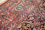 Fine, tight knotting reveals intricate Persian Isfahan floral motifs in saturated purple and gold.