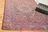 Intricately woven vintage Isfahan rug with rich red borders and a dark, covered field design.