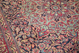 Isfahan rug detail, featuring tight knotting and deep purple field with red and teal patterns.