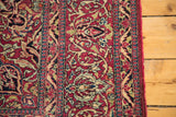 Finely woven curvilinear motifs on a vintage Isfahan rug in rich red, ivory, and blue.
