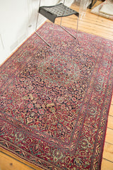 Fine, tight knotting reveals deep purple and red curvilinear floral motifs on this Isfahan rug.