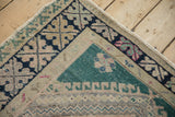 Corner detail of a vintage Oushak rug showing the geometric border and hand-knotted texture.