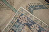 Reverse view of a vintage Oushak rug showing the hand-knotted foundation and folded corner.