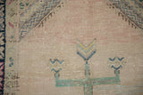 Detail of even wear to knot heads and a geometric motif on a vintage Oushak rug.