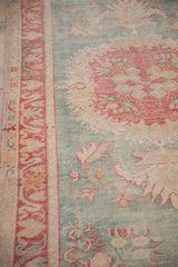 Decorative wear on vintage Oushak rug, seafoam green field with cherry red border.