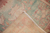 Hand-knotted Turkish Oushak rug showing distressed seafoam green pile, woven foundation, and fringe.