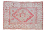 Vintage distressed Oushak carpet with a red diamond medallion on a faded silver-slate and ivory ground.