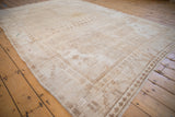 Worn sand and beige Distressed Oushak carpet, featuring a subtle lattice field and geometric border.