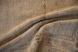 Distressed Oushak rug pile, showing even wear and faint foundation in neutral sand tones.