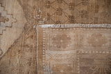 Textured pile, original side cord selvage, and woven foundation of the distressed Oushak carpet.