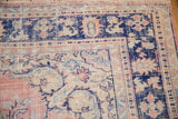 Distressed Oushak corner with floral spandrel, serrated border, dusty pink, cobalt blue, ivory.