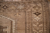 Distressed vintage Kars carpet with fringed edge, brown geometric and wave borders.