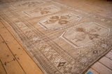 Kars carpet detail: distressed oversized floral gul medallion and wave motif border.