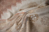 Distressed vintage Oushak rug showing soft pile, stepped pattern, and faded beige tones.