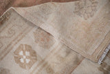 Hand-knotted foundation and intact side cord selvage of vintage distressed Oushak rug.