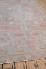Hand-knotted texture and soft pastel palette of a distressed vintage Oushak rug.