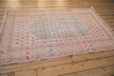 Vintage Distressed Oushak rug border with meandering floral vines in faded raspberry and sand.