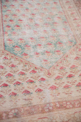 Worn pile of a vintage Oushak rug with pale turquoise and cherry red boteh motifs.