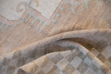 Distressed pile of vintage Oushak rug with softened texture and abrashed sandalwood field.