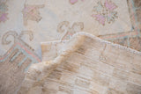 Detail of abrashed texture and woven foundation of vintage distressed Oushak rug.