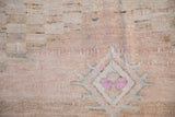 Distressed sandalwood Oushak rug pile with fuchsia and oxidized silver geometric motif.