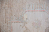 Light sandalwood hue of the hand-knotted vintage Oushak rug's foundation.