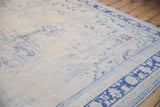 Vintage Distressed Oushak carpet with worn blue floral motifs and visible foundation.