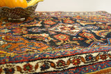 Vibrant hand-spun wool pile featuring tribal motifs and abrash on a colorful Bijar rug.