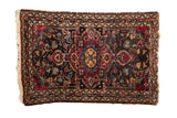 Vintage Lilihan square rug featuring a pomegranate medallion in red and blue on a dark floral field.