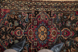 Hand-knotted pile and visible knot heads on a vintage Persian Lilihan rug with floral details.