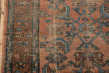 Worn pile detail of antique Kurdish Hamadan rug, revealing tattered edge and blue abrash.