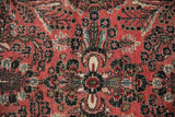 Vintage Dargezine rug detail: traditional floral sprays, delicate vines in faded raspberry, dark navy.