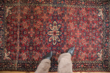 Vintage Hamadan rug, cherry red field displaying intricate Herati patterns and a central starburst medallion.