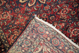 Hand-knotted reverse, intact side cord selvage, and red, blue, beige Herati pattern of a vintage Hamadan rug.