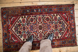 Borchalou rug's diamond medallion and large Herati pattern in red, blue, and ivory.