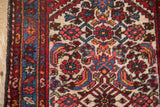 Hand-knotted Borchalou rug detail with ivory Herati pattern, cherry red, and sky blue serpent border.
