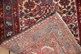 Vintage Borchalou rug corner, featuring intricate red, blue Herati pattern and hand-knotted foundation.