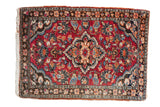 Hand-knotted Lilihan rug, central floral blossom medallion, palmette field, red, blue, black.