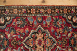 Vintage Lilihan rug with intricate floral motifs in cherry red, sky blue, charcoal, and ivory.
