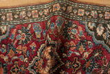 Vintage Lilihan rug detail showing cherry red field, blue palmettes, and intact side selvage.