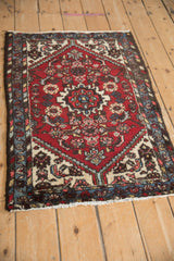 Nuanced roundel medallion with serrated contour on cherry red Borchalou rug.