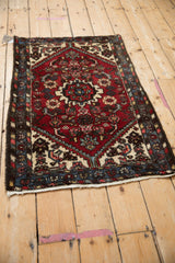 Vintage Borchalou rug corner detail with ivory serrated contour and red Herati design.