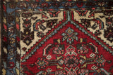 Vintage Borchalou rug detail, Herati motif, serrated field contour, cherry red, and ivory.
