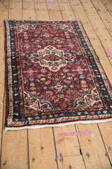 Angled view displaying the thick, even wool pile of a vintage Hamadan rug with floral motifs.