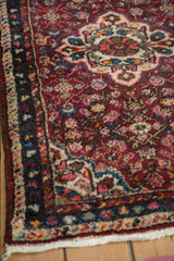 Close-up showing the blossoming wool pile and corner spandrel of a vintage Hamadan rug.